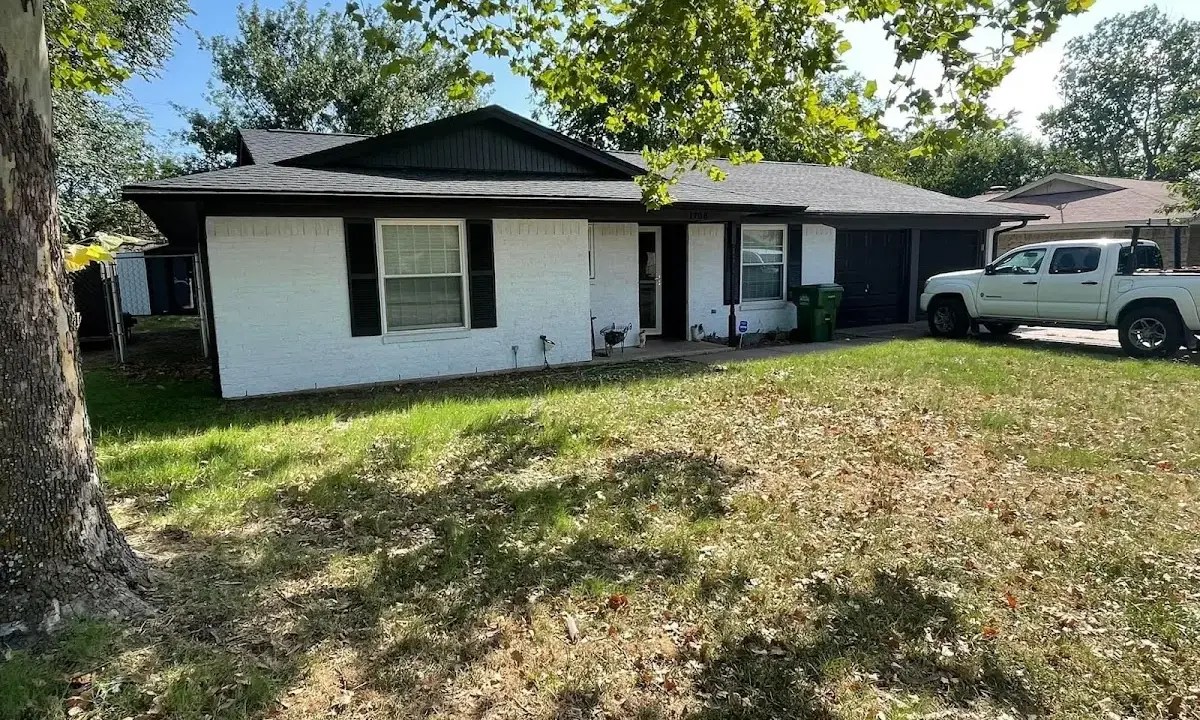 Professional roofing crew working on a residential roof in East Longmeadow